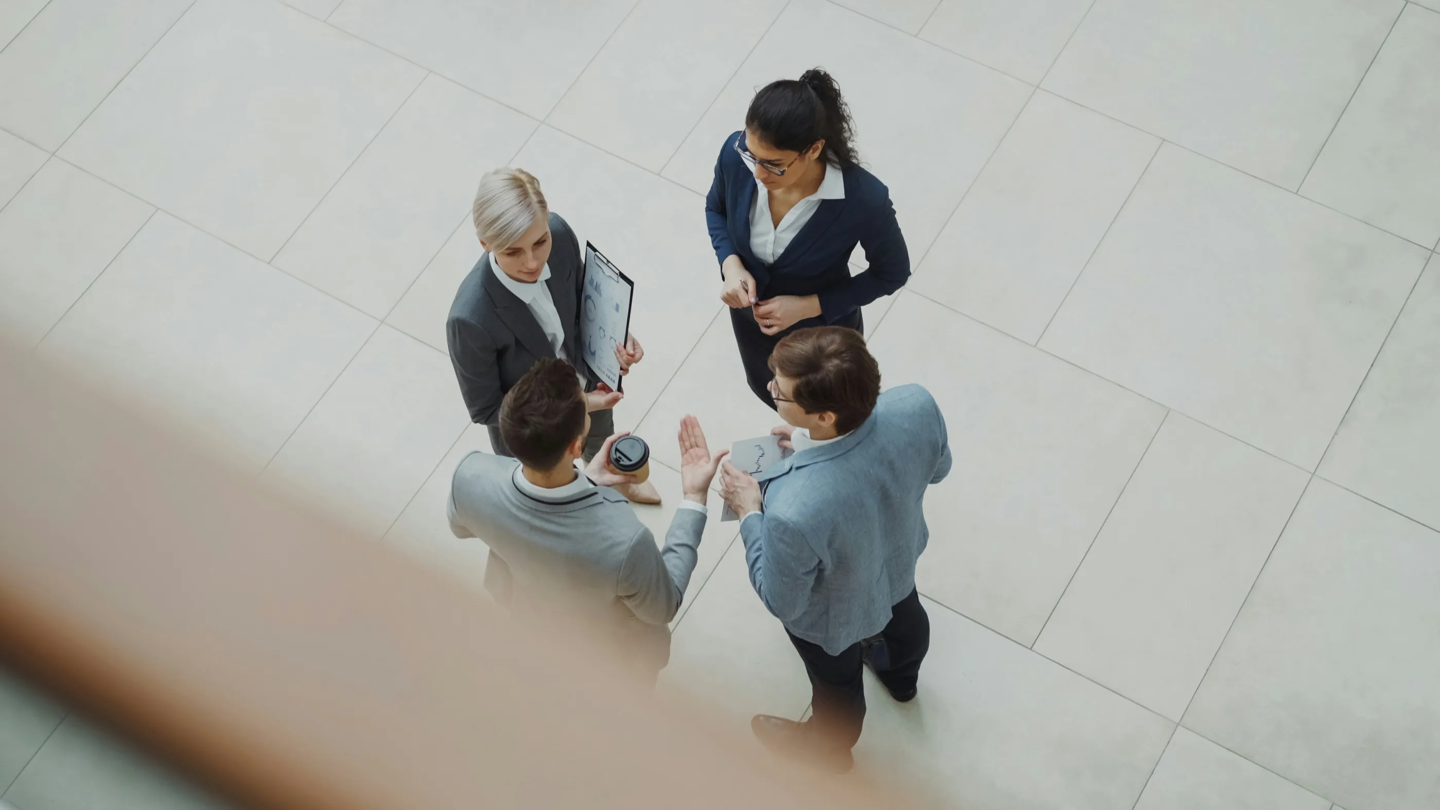 Colleagues talking in a bright office, seen from above